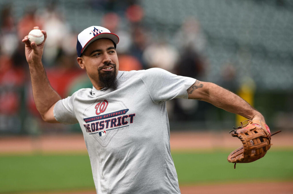 Anthony Rendon mid-throw in casual Washington Nationals t-shirt on baseball field wallpaper background
