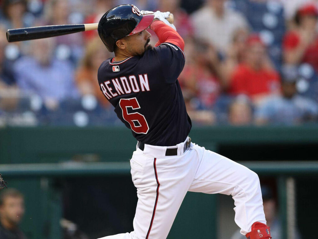 Anthony Rendon mid swing in dark blue uniform dynamic baseball action wallpaper background