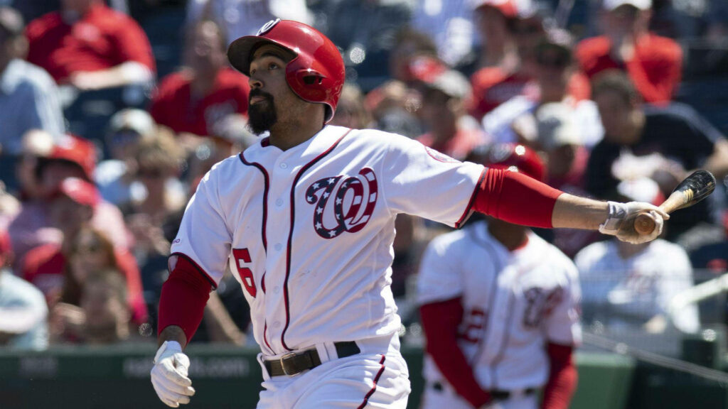 Anthony Rendon swings baseball bat in Washington Nationals uniform at vibrant stadium game Wallpaper