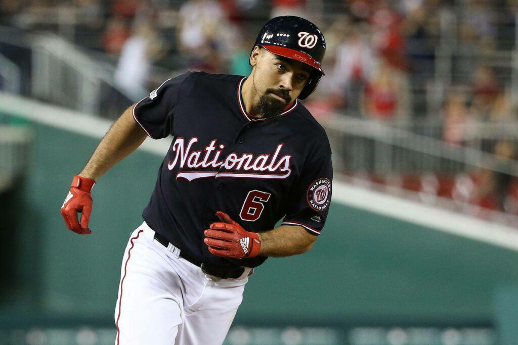 Anthony Rendon running in dark blue Nationals shirt during intense baseball game action wallpaper