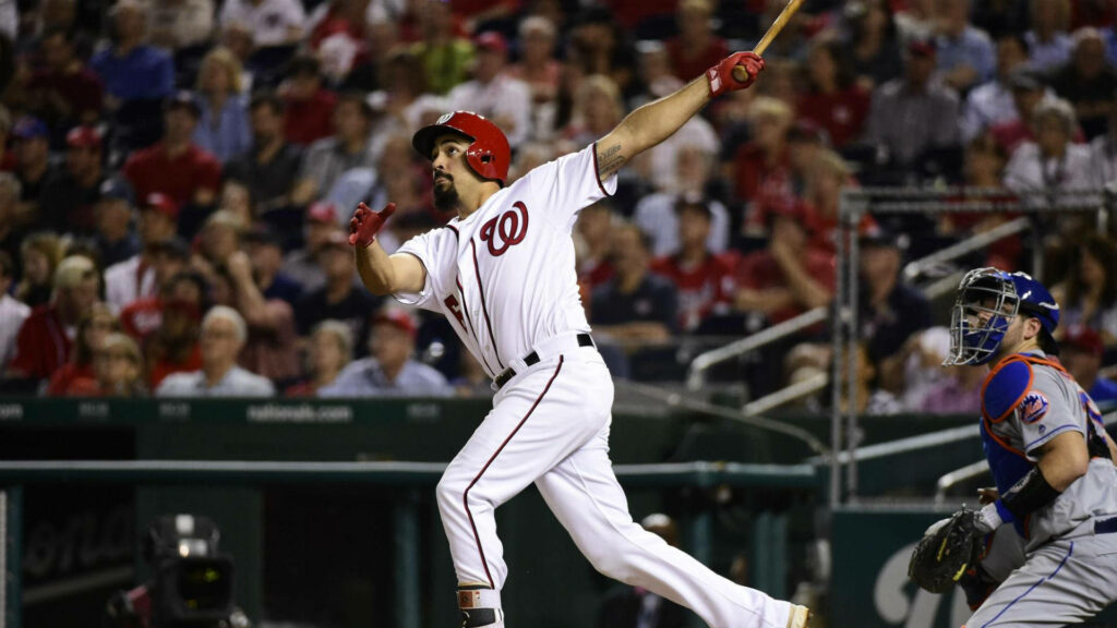 Anthony Rendon running with bat after hit showcasing focus and athleticism in baseball game wallpaper