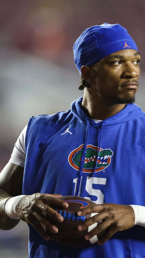 Anthony Richardson in Florida Gators gear holding football focused dynamic sports wallpaper