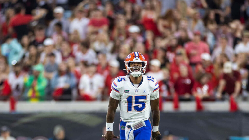 Anthony Richardson in Florida Gators uniform ready on football field with focused crowd background Wallpaper