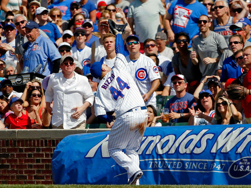 Anthony Rizzo Chicago Cubs catching ball near stands with dirty pants and excited crowd wallpaper