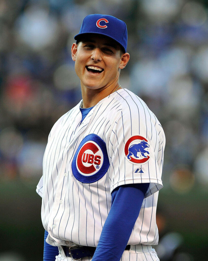 Anthony Rizzo smiling joyfully in Chicago Cubs pinstripe uniform baseball field wallpaper background
