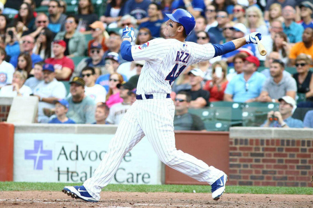 Anthony Rizzo swinging bat in Chicago Cubs uniform during baseball game with fans watching Wallpaper