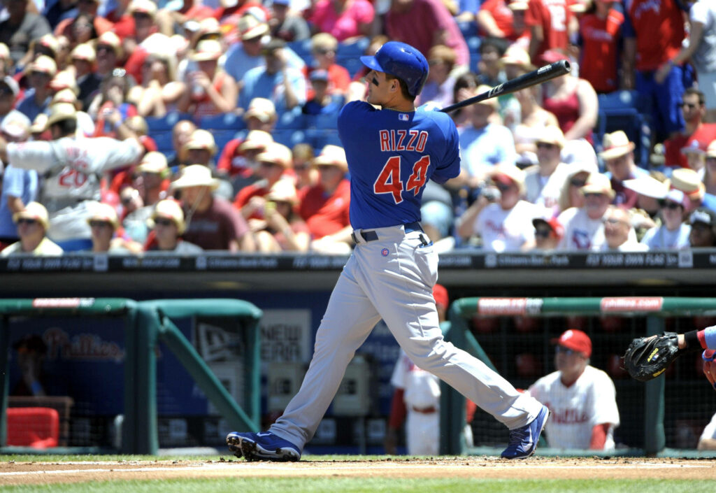 Anthony Rizzo mid-swing in Chicago Cubs uniform batting during baseball game action wallpaper