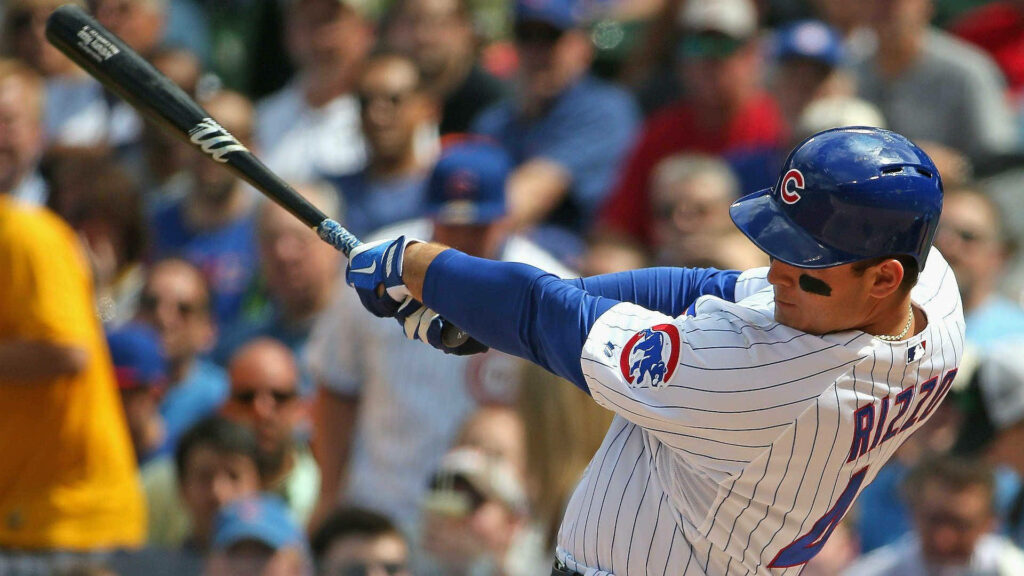 Anthony Rizzo swinging bat powerfully during Chicago Cubs game action wallpaper background