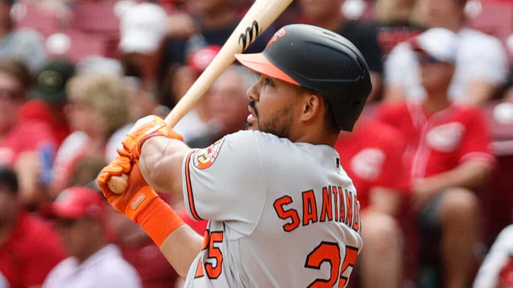 Anthony Santander mid-swing baseball player intense focus powerful batting action wallpaper background