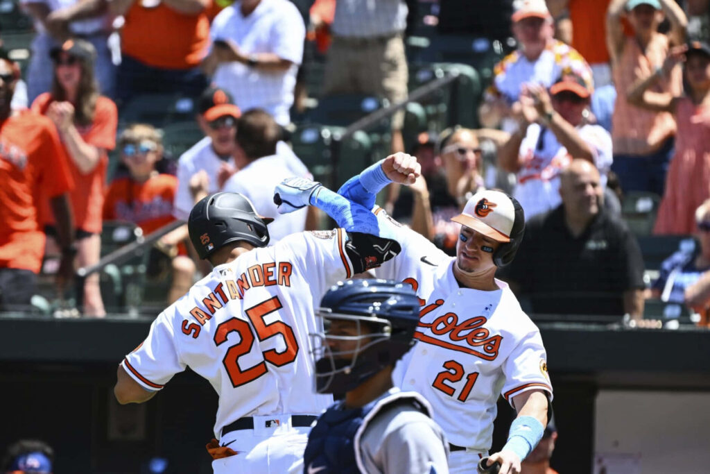 Anthony Santander celebrates big baseball play with Orioles teammates energetic game moment wallpaper