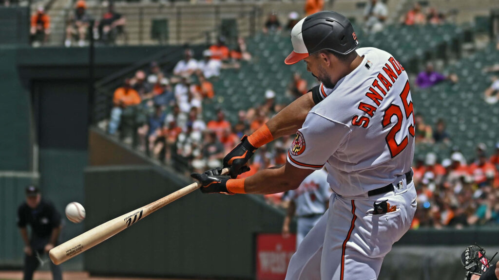 Anthony Santander swings powerfully hitting baseball during high-energy game action wallpaper