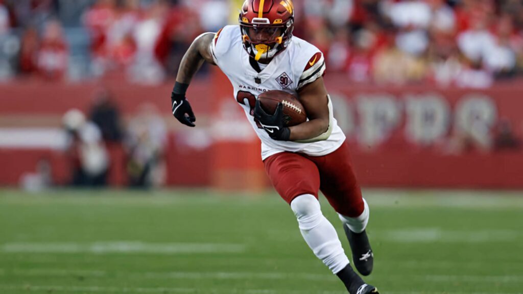 Antonio Gibson sprinting powerfully in football action showcasing athleticism and determination Wallpaper
