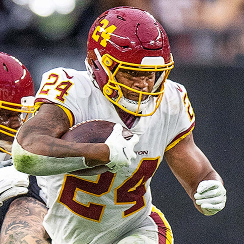 Antonio Gibson in Number 24 jersey powering forward in dynamic football action on field wallpaper