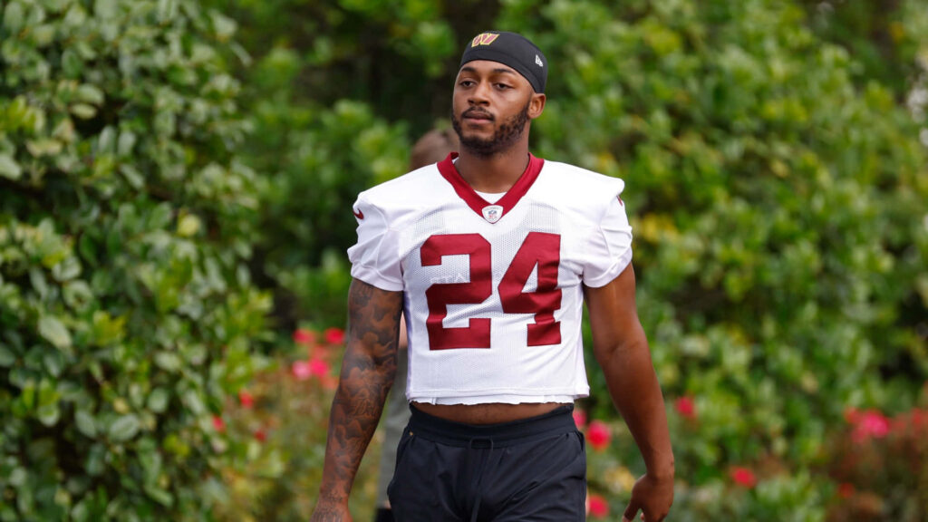 Antonio Gibson number 24 training outdoors in lush greenery showcasing athletic focus wallpaper