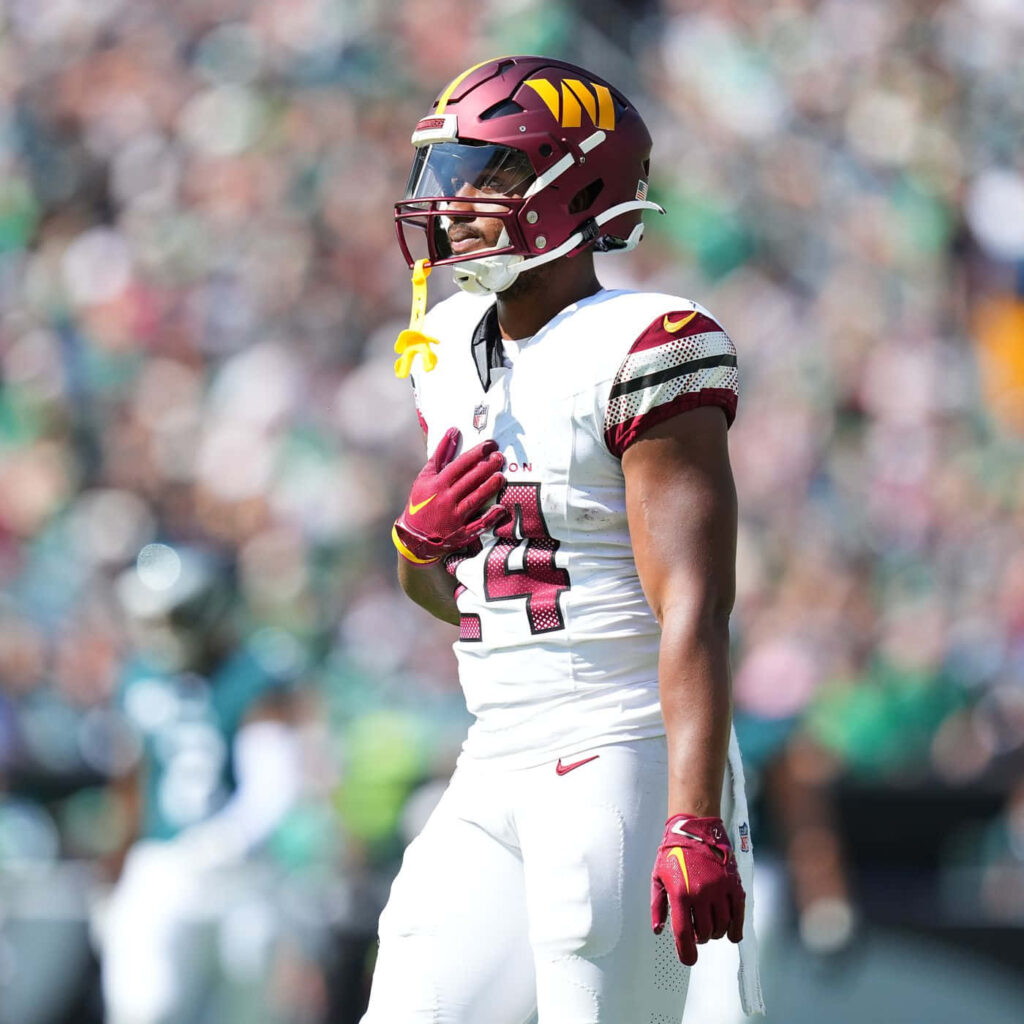 Antonio Gibson in Washington Commanders uniform focused in action during football game wallpaper background