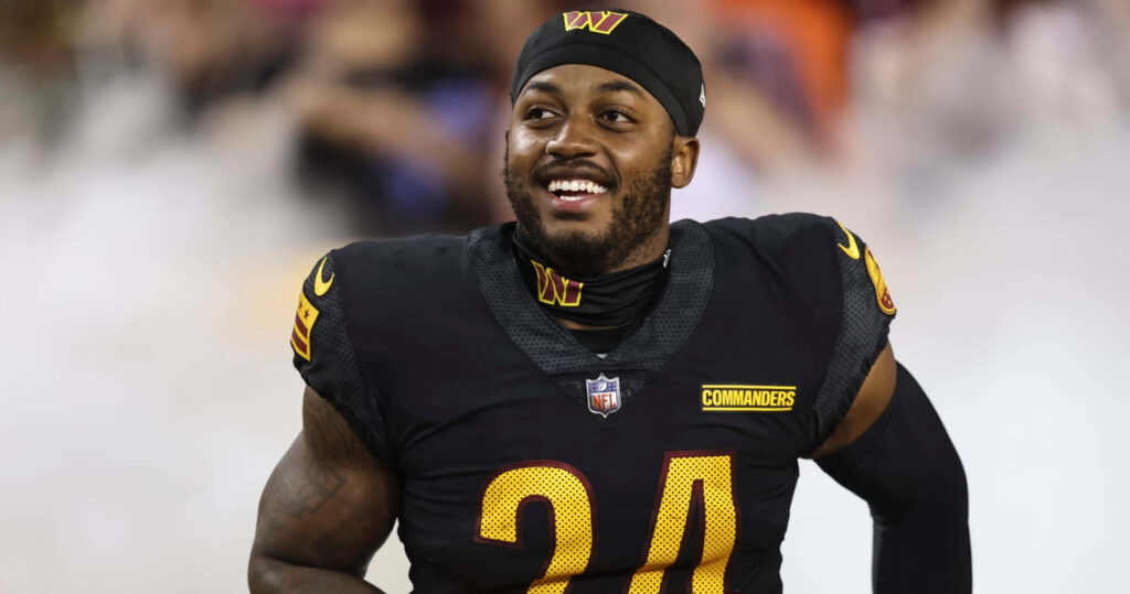 Antonio Gibson smiling in Washington Commanders uniform showing confidence and energy on field Wallpaper