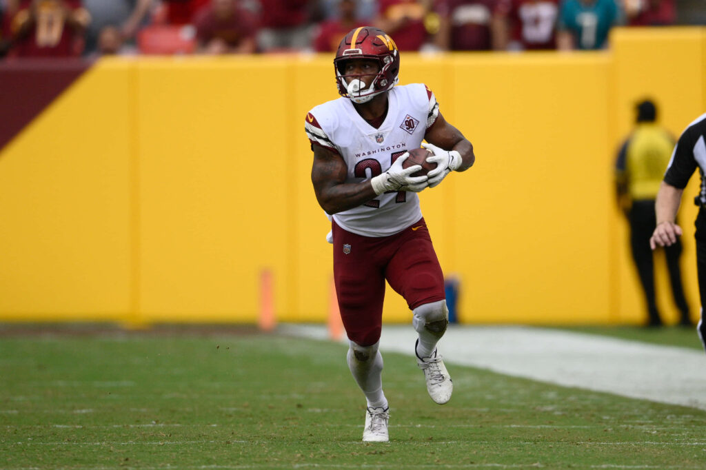 Antonio Gibson Washington Football Team sprinting with football dynamic running back wallpaper