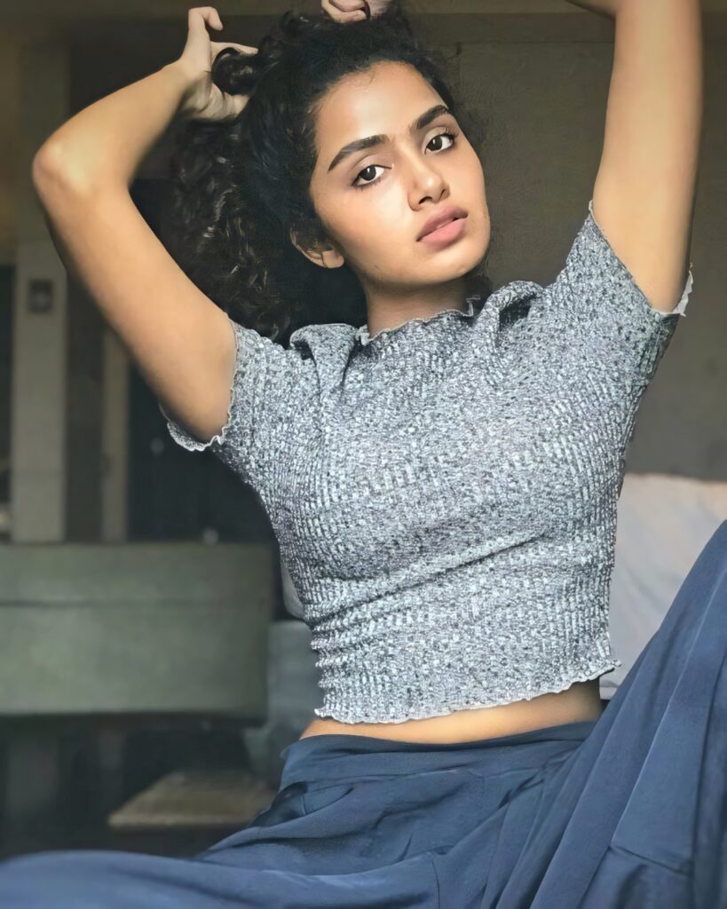 Anupama Parameswaran confident in textured grey top stylish natural wallpaper background