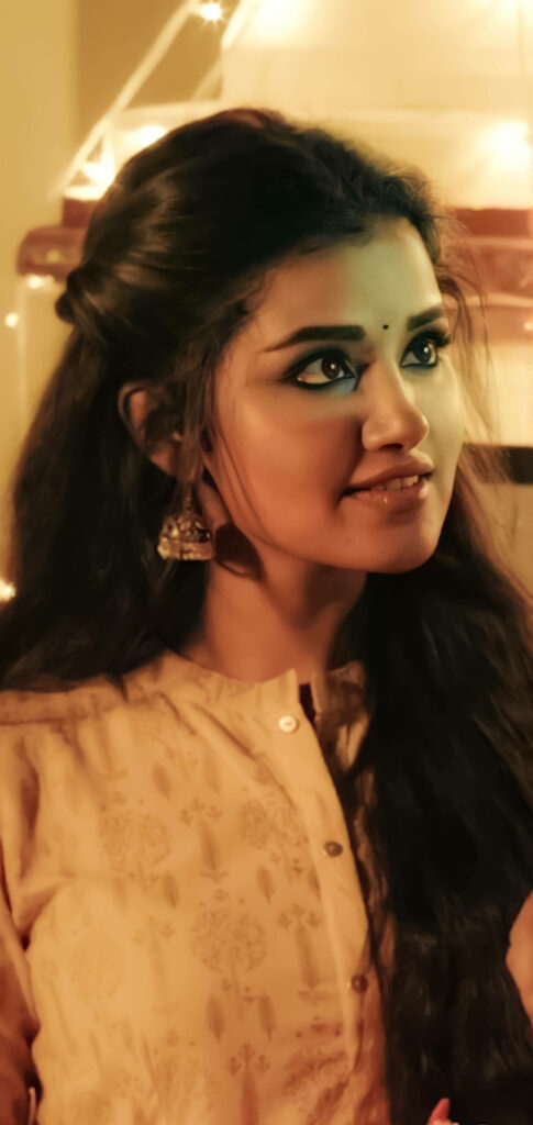 Anupama Parameswaran in traditional attire with soft lighting highlighting her expressive eyes wallpaper