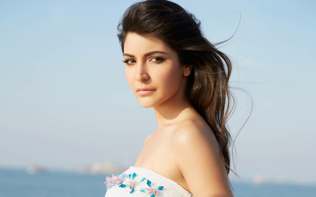 Anushka Sharma stunning half shot outdoor portrait with flowing hair and natural soft expression Wallpaper