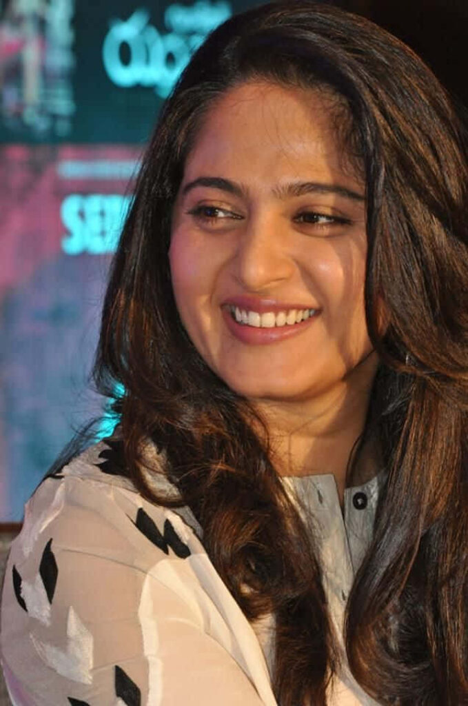 Anushka Shetty smiling brightly at event elegant radiant look wallpaper background image