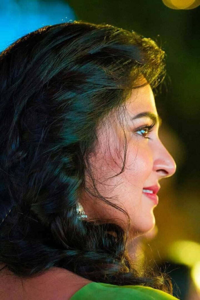 Anushka Shetty profile side view glowing elegant features soft light blurred wallpaper background