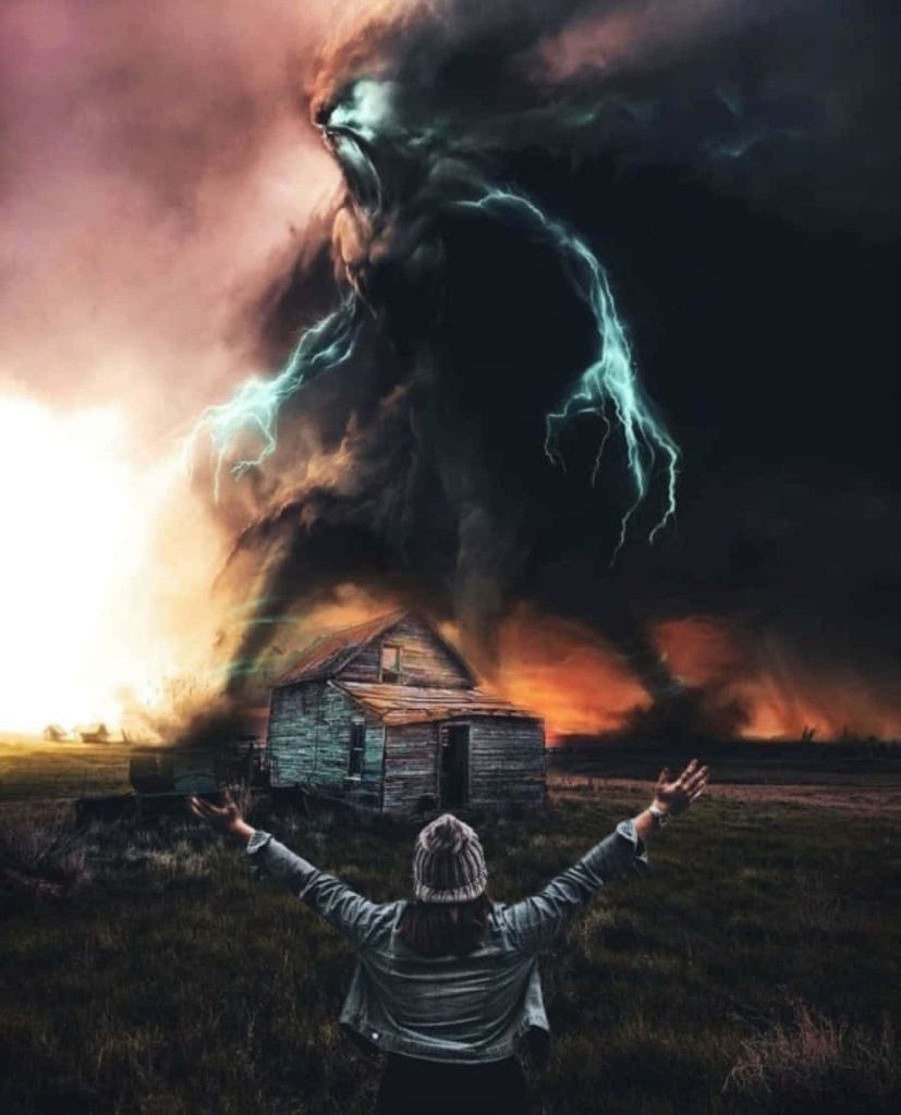 Person facing rustic shack under stormy sky with massive spectral entity and lightning strikes Wallpaper