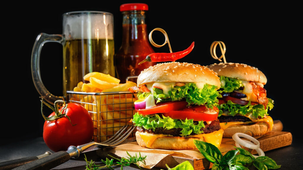 Appetizing Cheeseburger Wallpaper with Beer & Fries on Dark Background