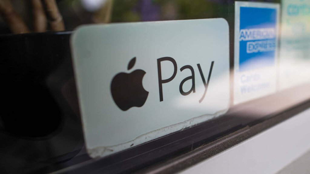 Apple Pay logo sticker beside American Express sign representing digital payments and credit card acceptance Wallpaper