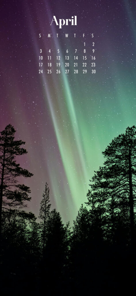 April 2022 calendar wallpaper of vibrant Northern Lights over pine trees and starry night sky
