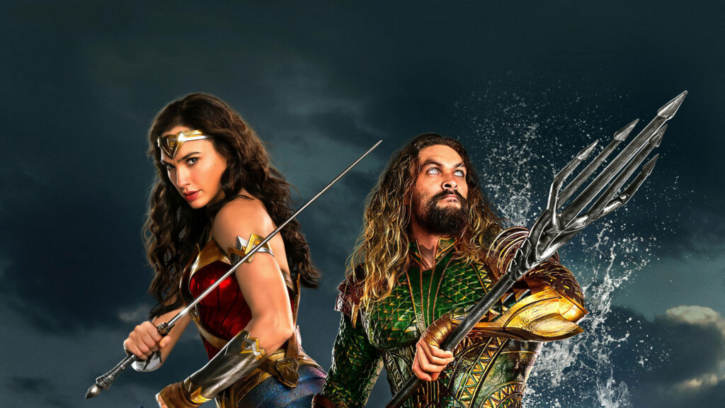 Aquaman with trident and Wonder Woman with sword pose powerfully by dramatic ocean background wallpaper