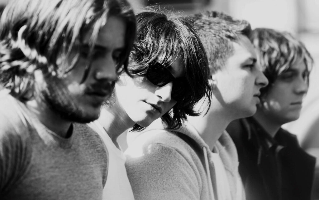 Monochrome close-up profile of Arctic Monkeys band members showcasing rock style wallpaper