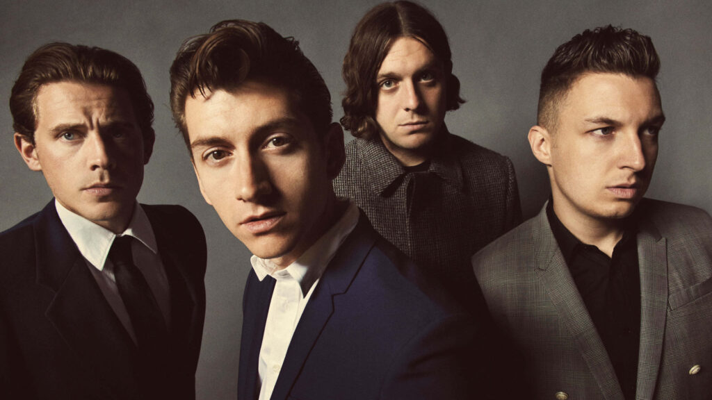 Arctic Monkeys band portrait with Alex Turner Matt Helders Jamie Cook Nick O'Malley in suits Wallpaper