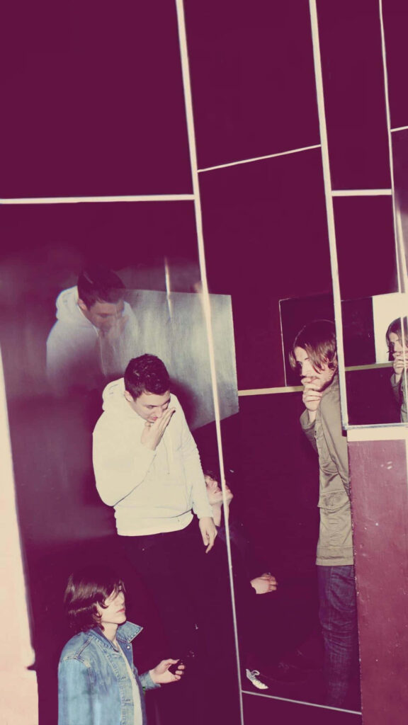 Arctic Monkeys band wallpaper with creative mirrored reflection in artistic modern background