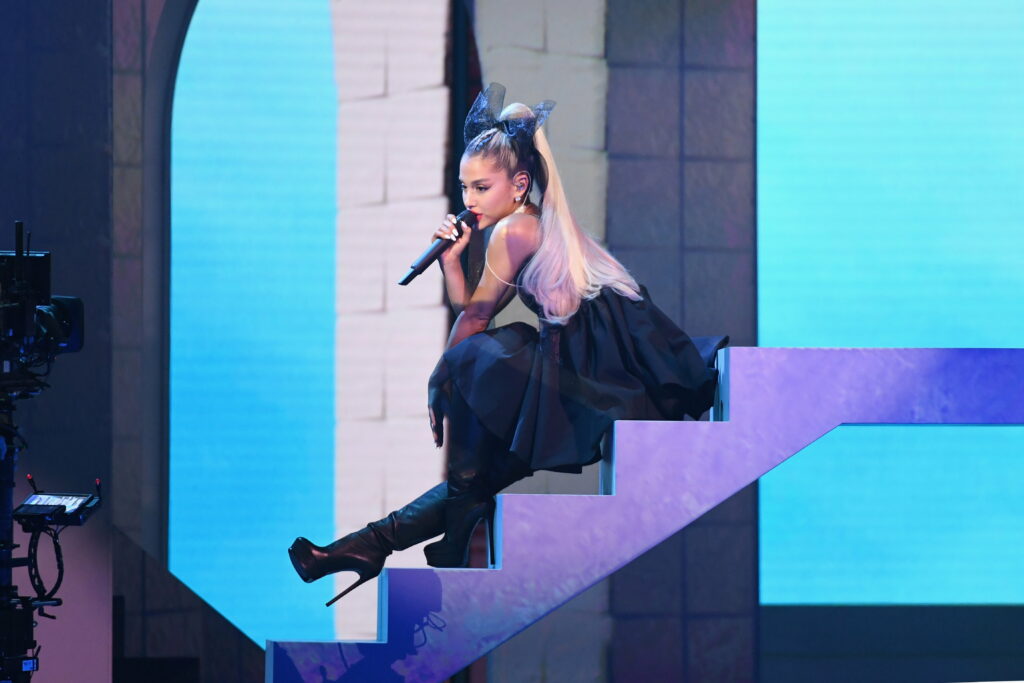 Ariana Grande: Captivating Melodies and Unforgettable Charisma - A Vibrant HD Wallpaper