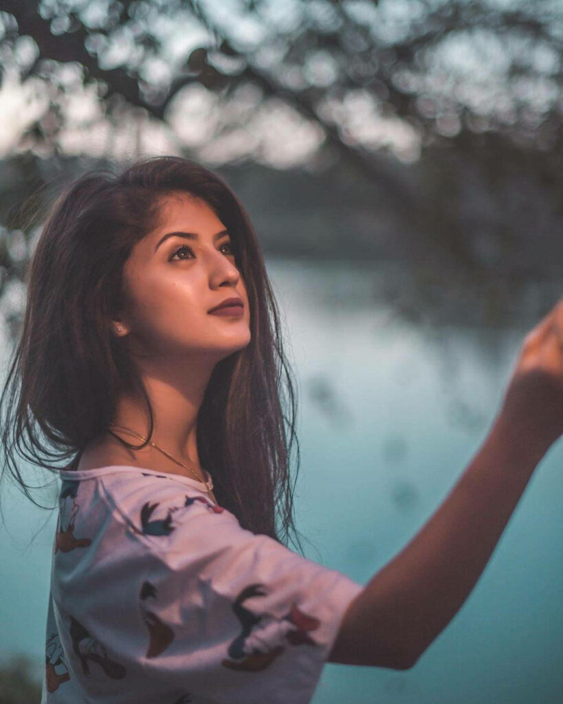 Arishfa Khan thoughtful gaze by calm lake soft natural light serene nature peaceful wallpaper