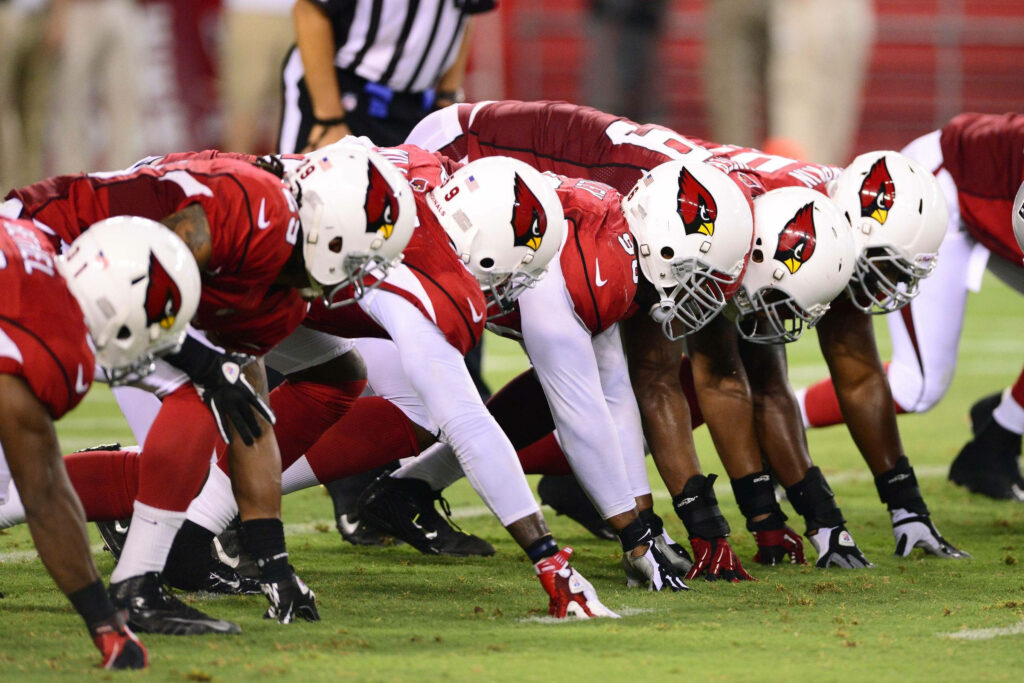 Arizona Cardinals football players lined up in formation ready for game action wallpaper background