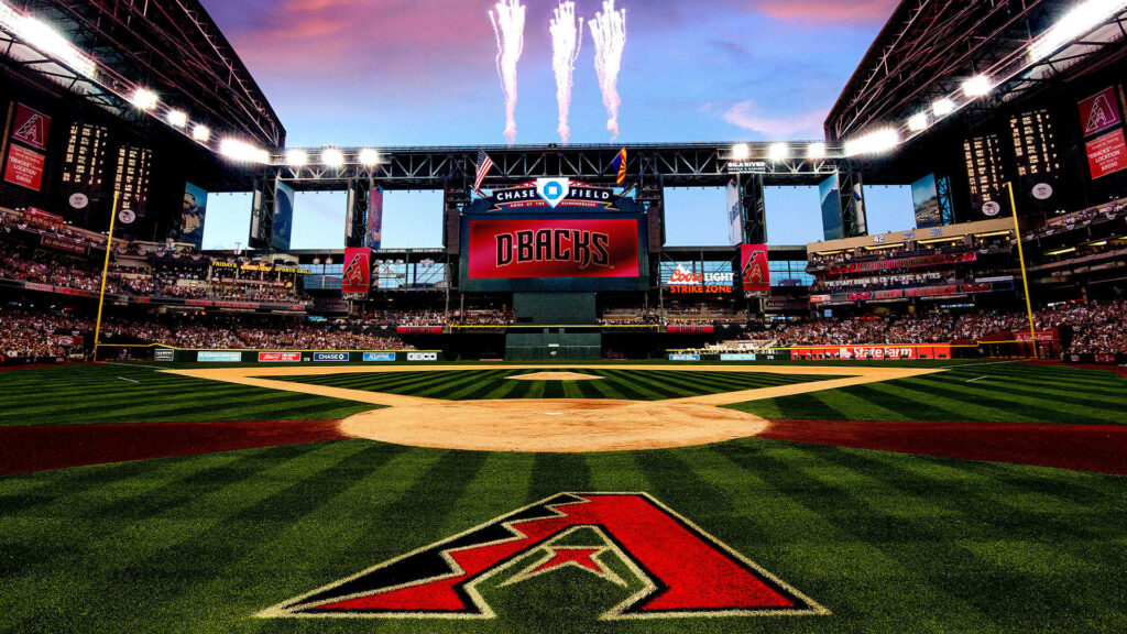 Arizona Diamondbacks baseball field at Chase Field with fireworks and team logo on grass Wallpaper