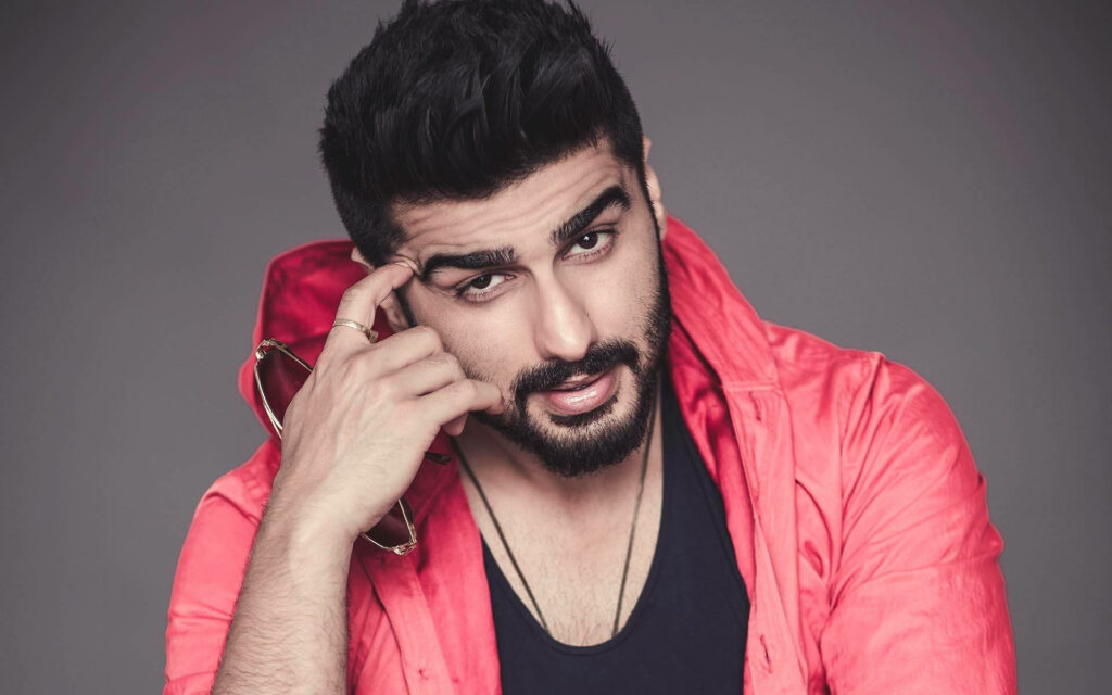 Arjun Kapoor confident pose red jacket charming smirk stylish wallpaper background image