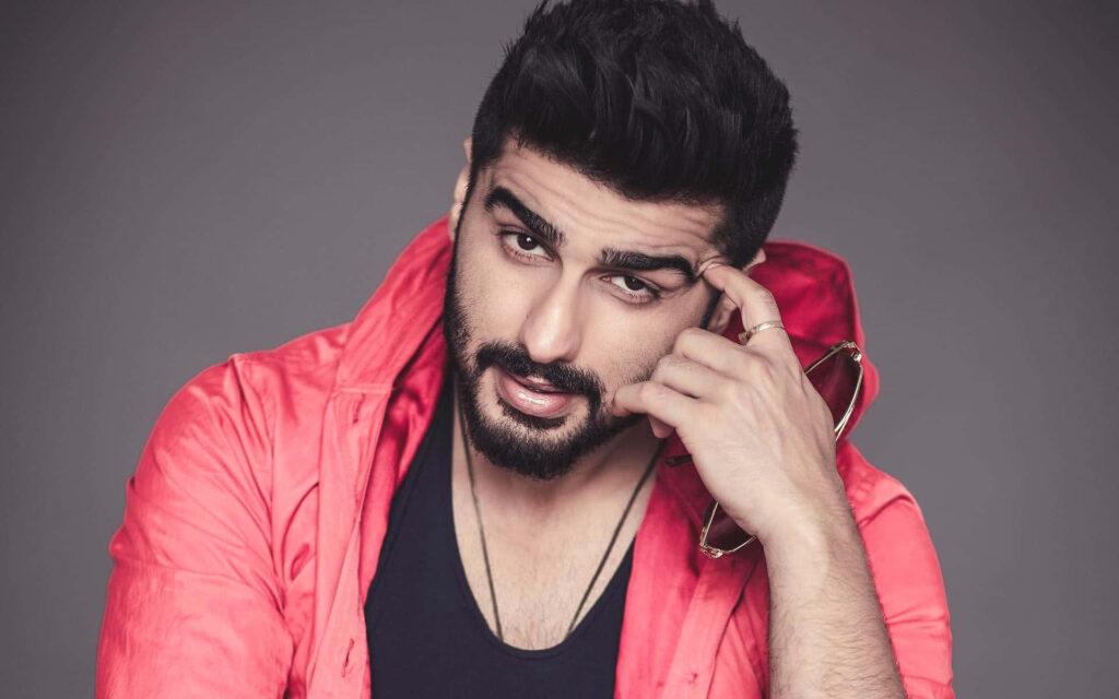 Arjun Kapoor in stylish red jacket striking confident pose high quality wallpaper background
