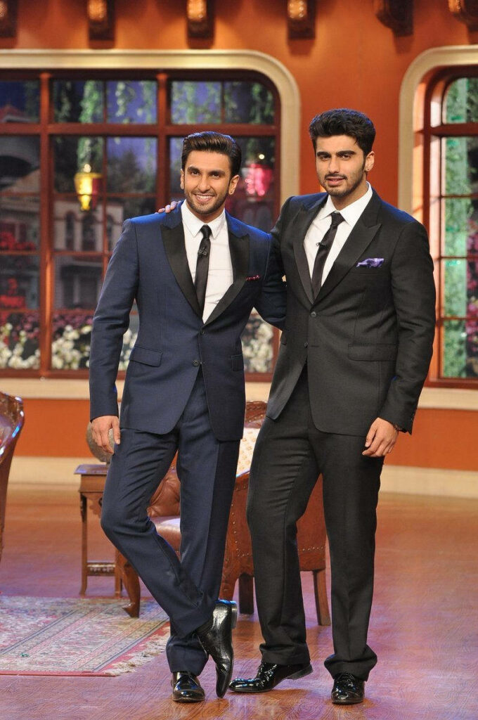 Arjun Kapoor and Ranveer Singh in stylish black suits posing together on vibrant indoor set wallpaper