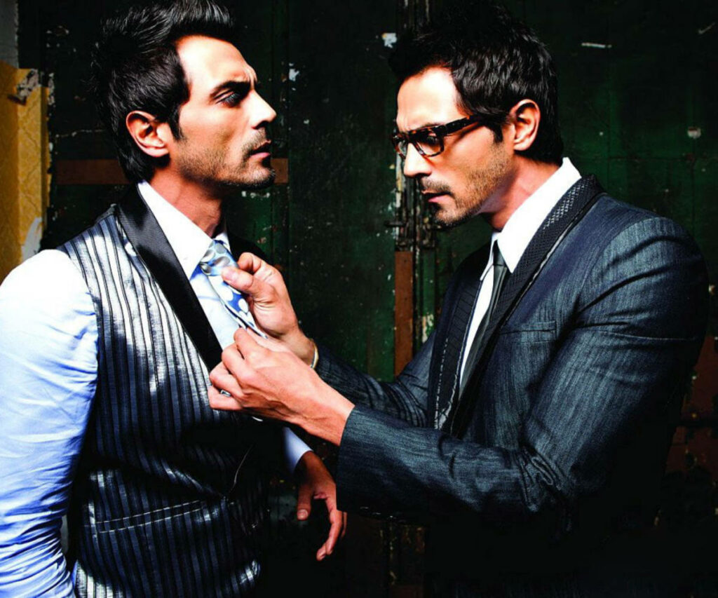 Arjun Rampal in double role adjusting tie with dramatic stylish look on wallpaper background