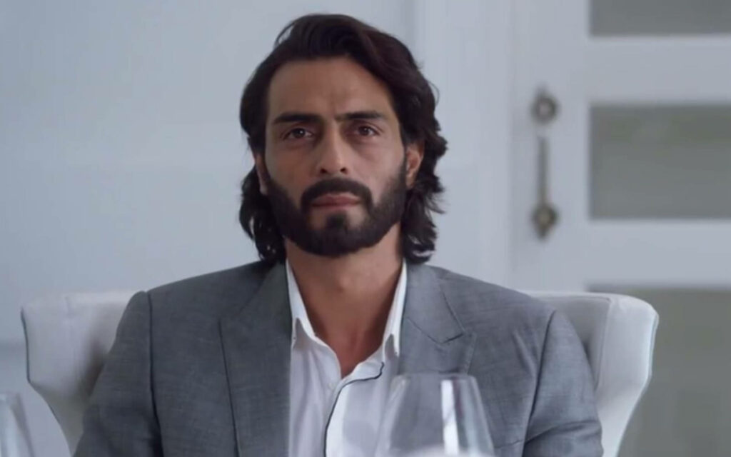 Arjun Rampal in grey suit seated calmly with confident expression elegant Indian actor wallpaper