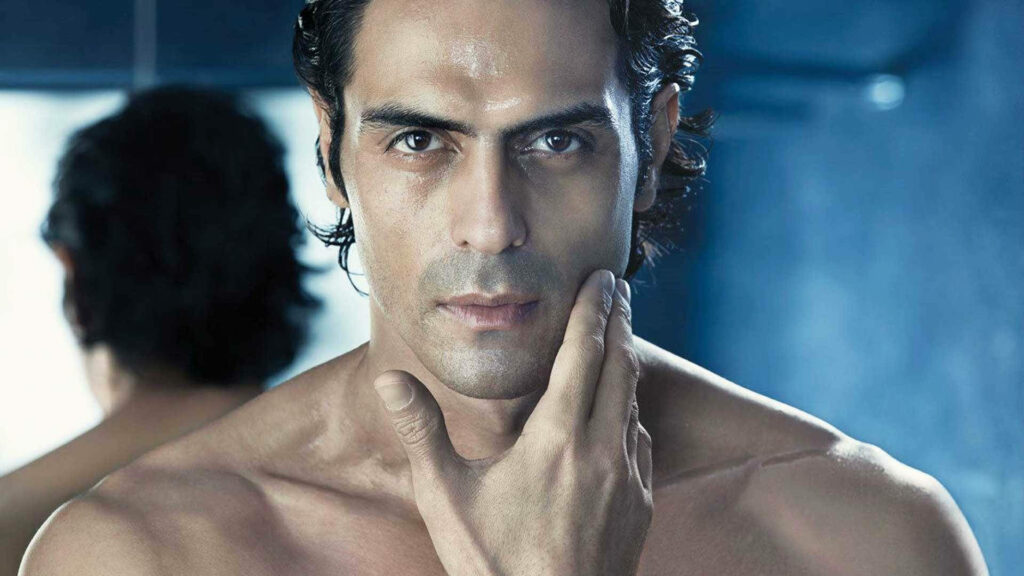 Arjun Rampal shirtless portrait thoughtful pose soft blue background intense wallpaper image