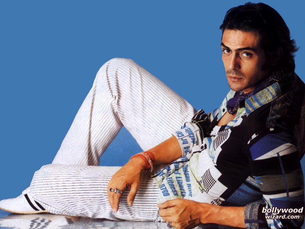 Arjun Rampal confident pose stylish look plain blue background captivating wallpaper image