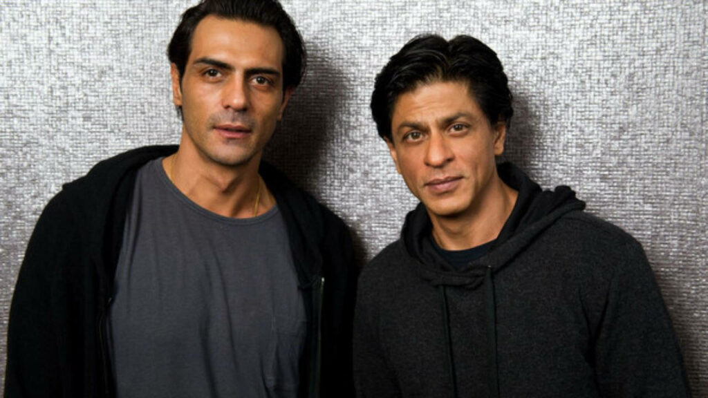 Arjun Rampal and Shah Rukh Khan in casual dark outfits standing side by side on textured background wallpaper
