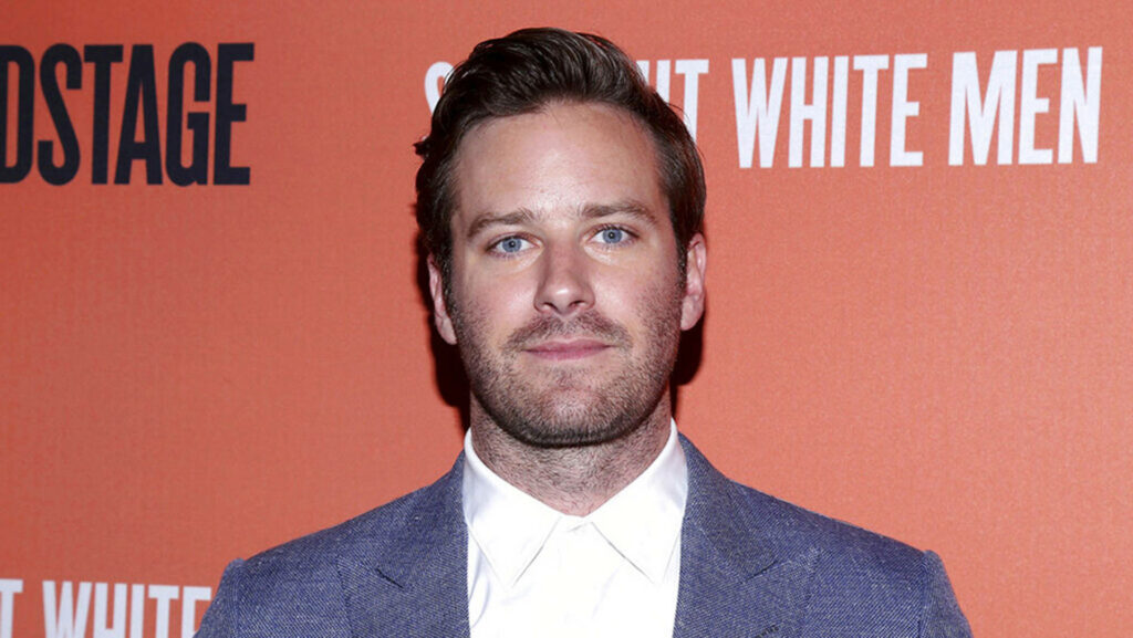 Armie Hammer posing confidently at Broadway night event with event backdrop wallpaper background