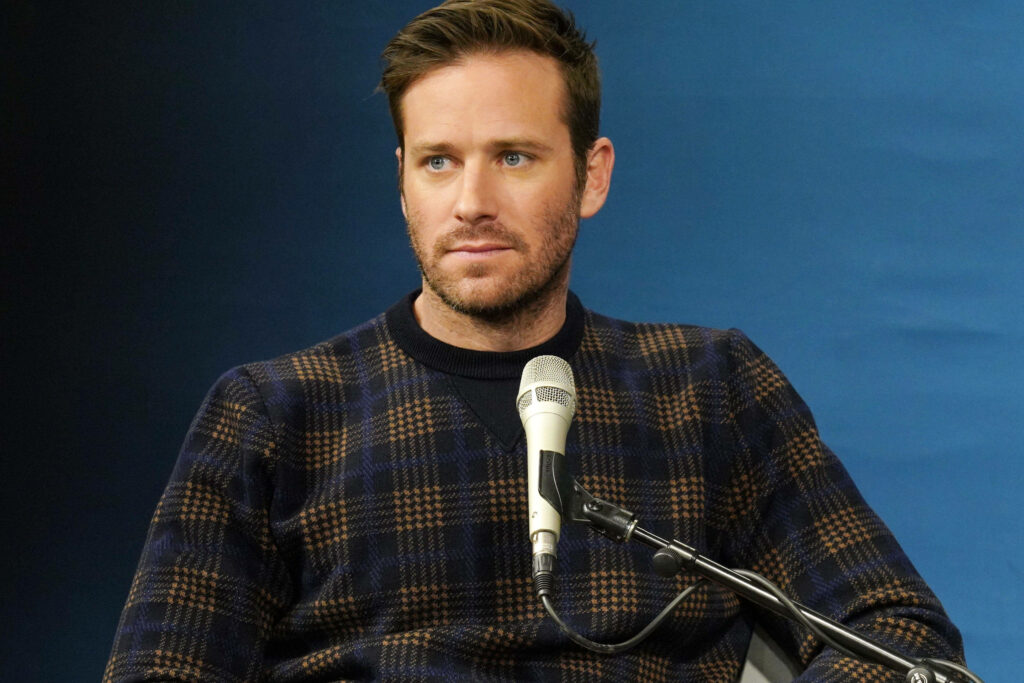 Armie Hammer in candid SiriusXM Spotlight interview with microphone blue background wallpaper