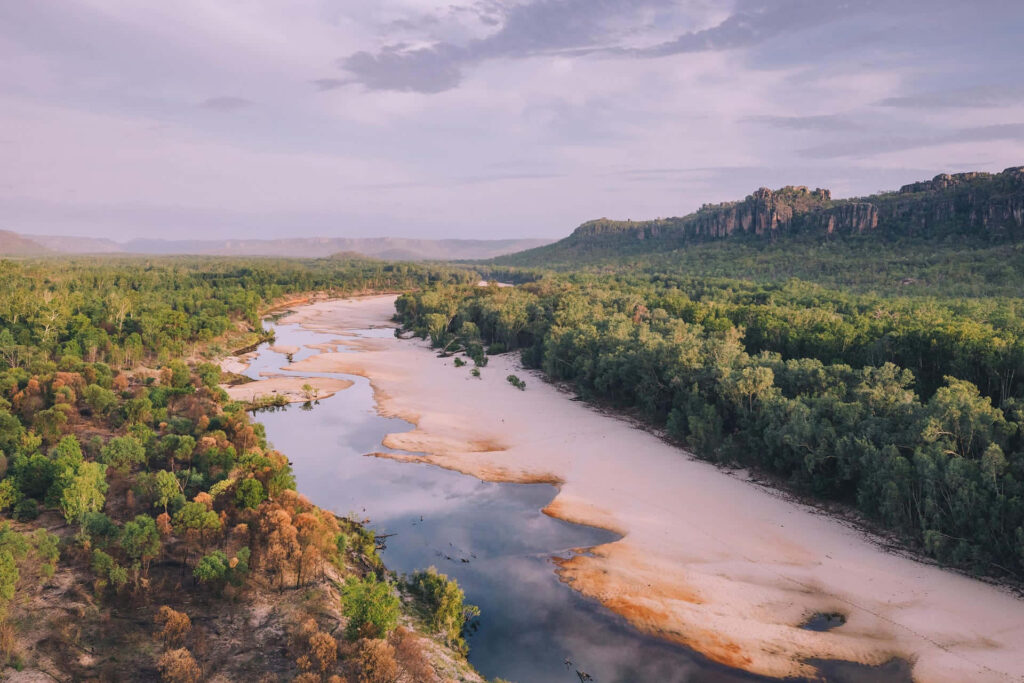 Aerial view of Arnhem Land river winding through lush forests and rugged terrain wallpaper