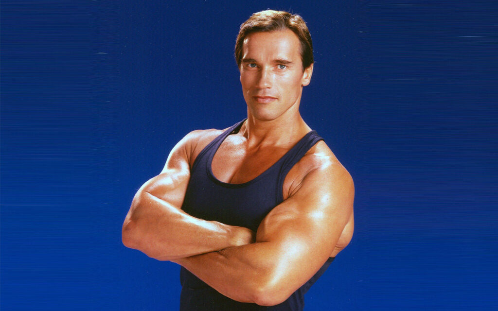 Arnold Schwarzenegger Wallpaper: Muscular Confidence on Blue Background